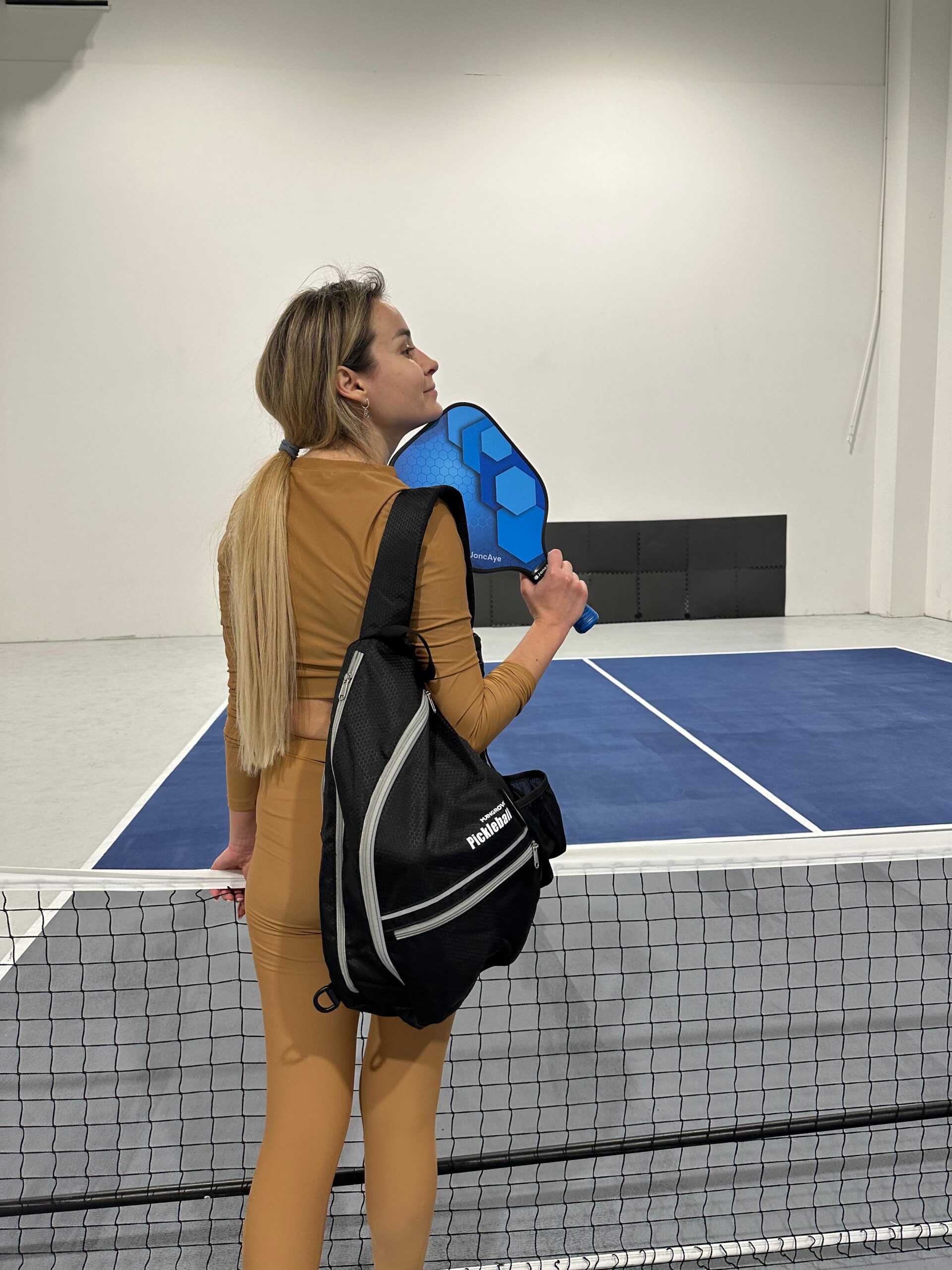 Mariia showing off the JoncAye pickleball paddle she bought on Amazon.