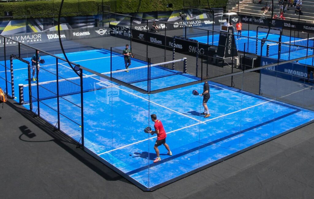 A photo of a blue padel court highlighting the difference in size between a padel vs pickleball court.