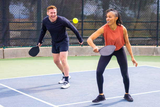 A team learning how pickleball scoring works in doubles