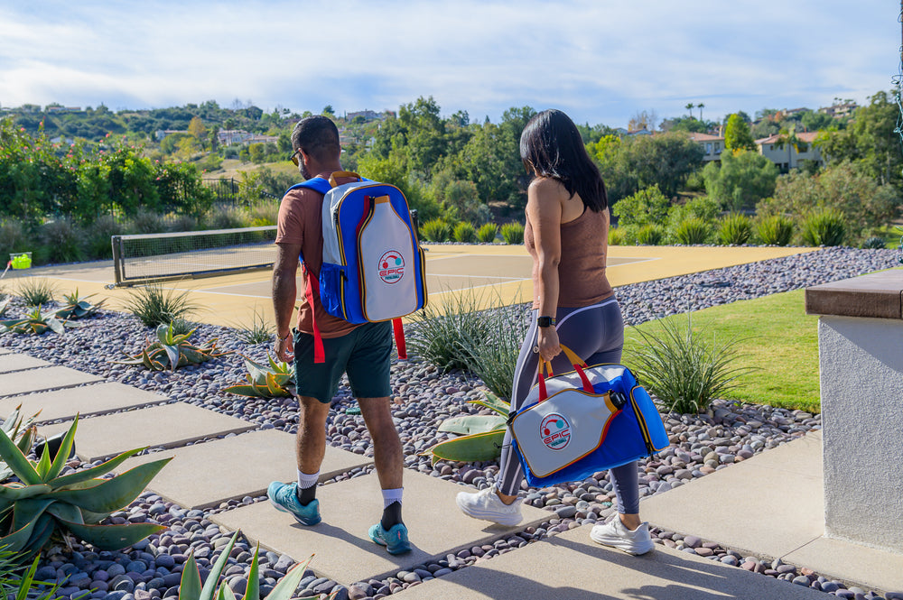 Man and women walking to the pickleball court with their Epic pickleball bags with a built in cooler