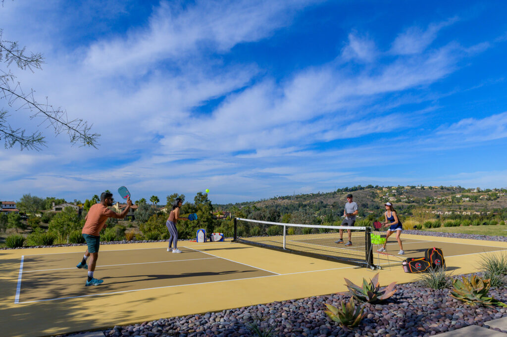 4 Pickleball players two men and two women playing Pickleball