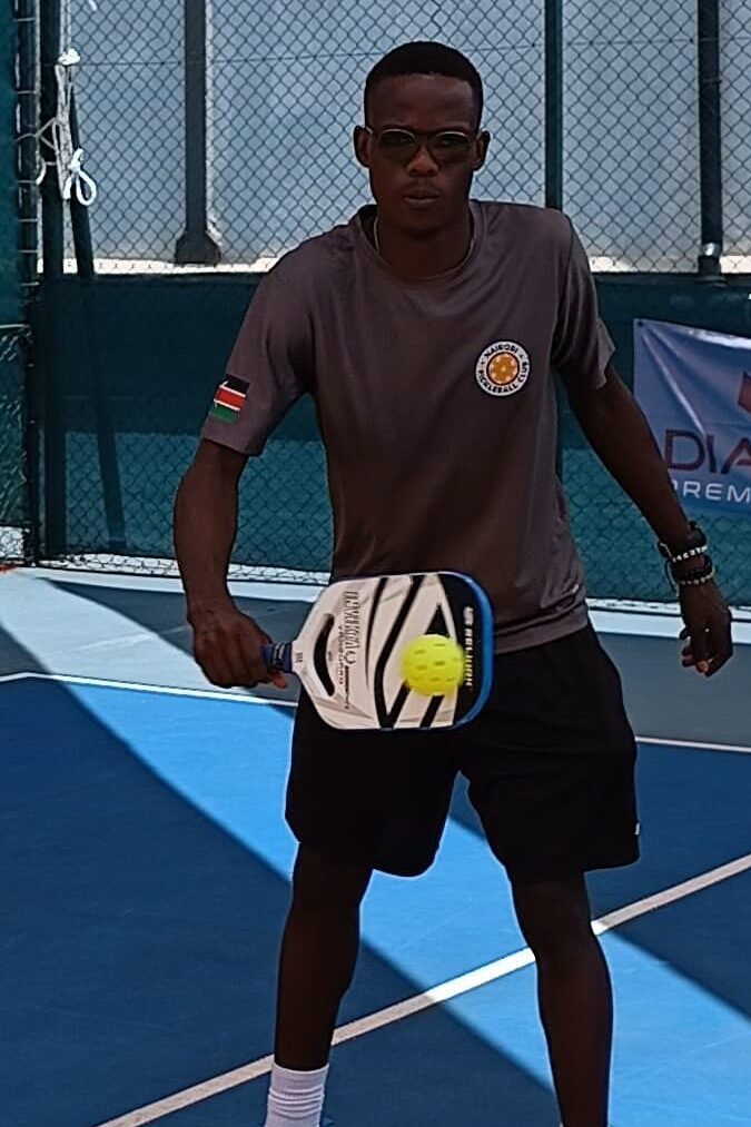 What is skinny pickleball: Player preparing to hit a backhand volley during a game of skinny singles.