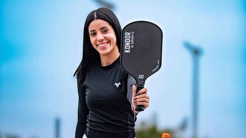 Kondor sponsored Muyasser Bresh wearing a black shirt and holding up a black paddle.