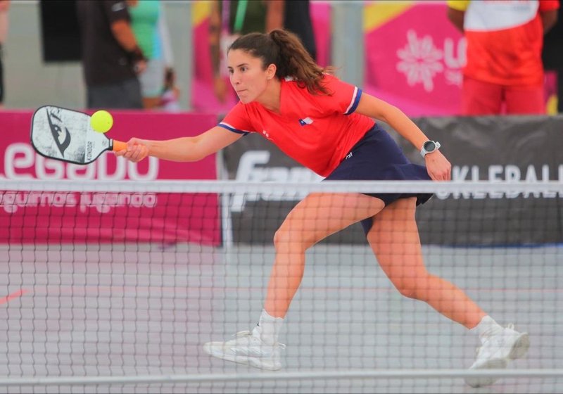 Kondor co-founder Michelle Hasson playing a drop shot on the pickleball court.