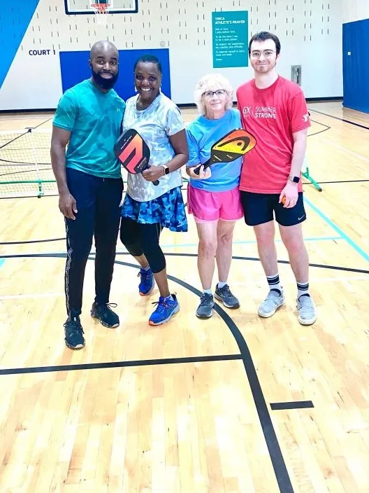 Sherry with her son and friends on a pickleball court in North Carolina