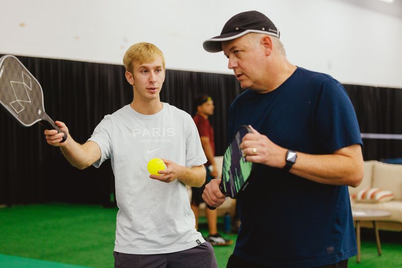 A men's doubles team strategize for their next shot at the Pickleball 901 Memphis facility.