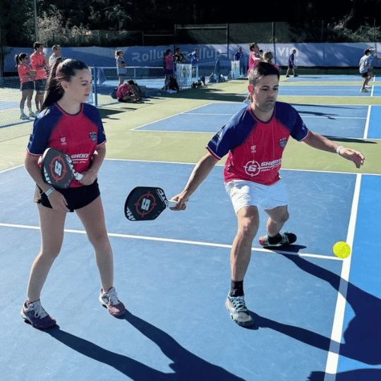 The mixed doubles team from Shooter Padel, eventual silver medalists in the Barcelona Pickleball Cup about to hit a dink shot